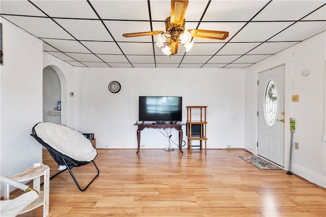 entryway with light hardwood / wood-style floors, a drop ceiling, and ceiling fan