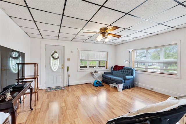 foyer with a paneled ceiling, hardwood / wood-style flooring, and ceiling fan