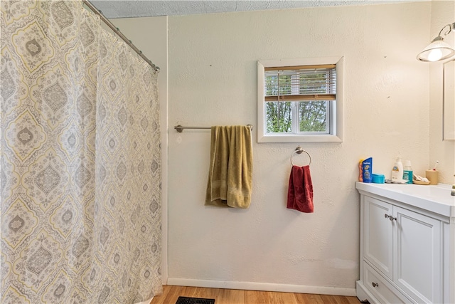 bathroom featuring vanity, a textured ceiling, and hardwood / wood-style flooring