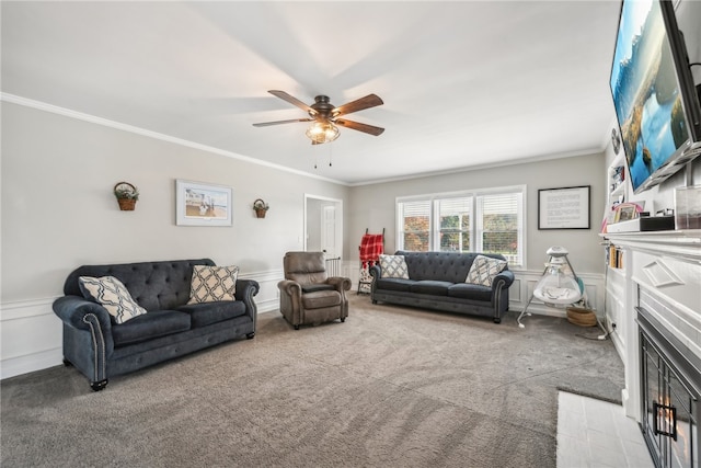 living room featuring ornamental molding, light carpet, and ceiling fan