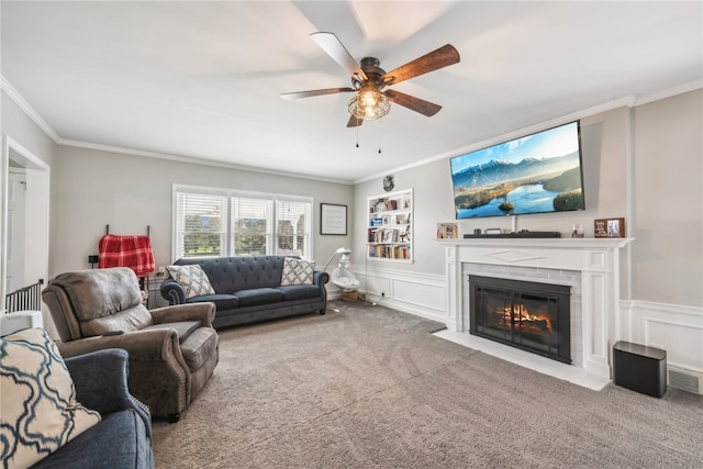 carpeted living room featuring ceiling fan and crown molding