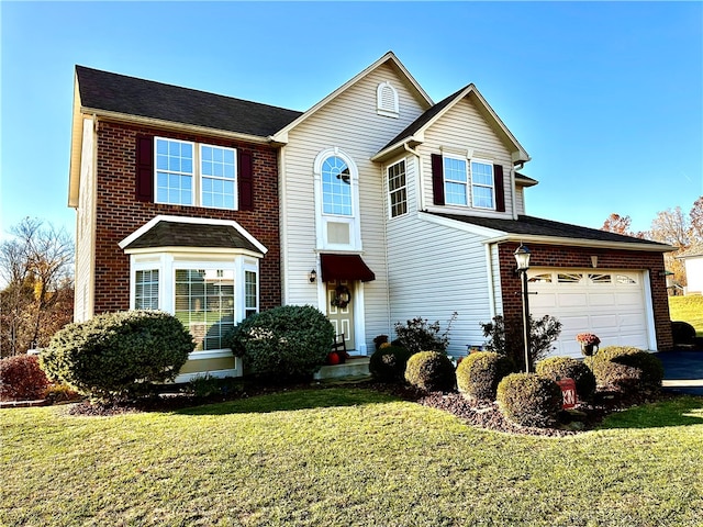 view of property featuring a front yard and a garage