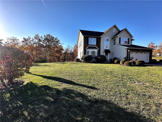 view of front facade featuring a front yard and a garage