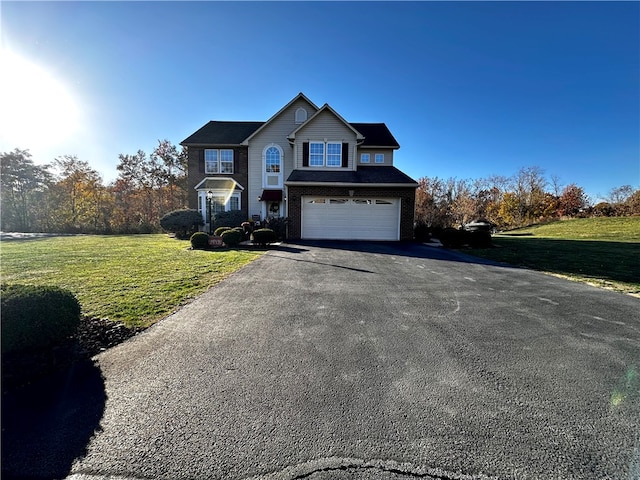 view of front property with a front yard and a garage