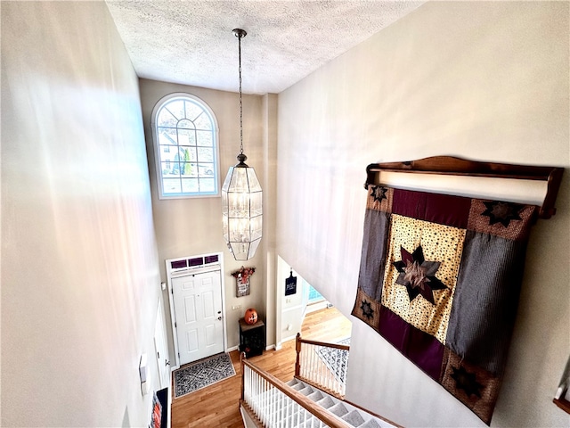 entryway with a textured ceiling and hardwood / wood-style floors