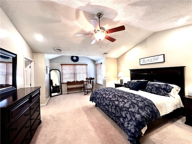 carpeted bedroom with ceiling fan, a textured ceiling, and vaulted ceiling