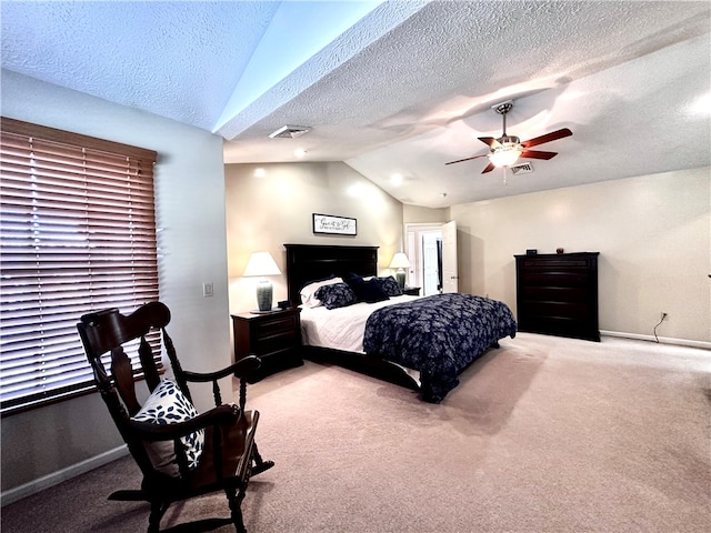 carpeted bedroom with a textured ceiling, vaulted ceiling, and ceiling fan