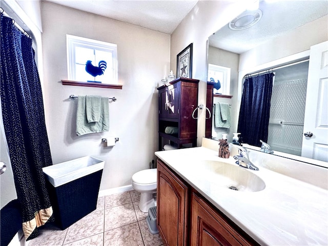 bathroom with toilet, a textured ceiling, vanity, and tile patterned floors