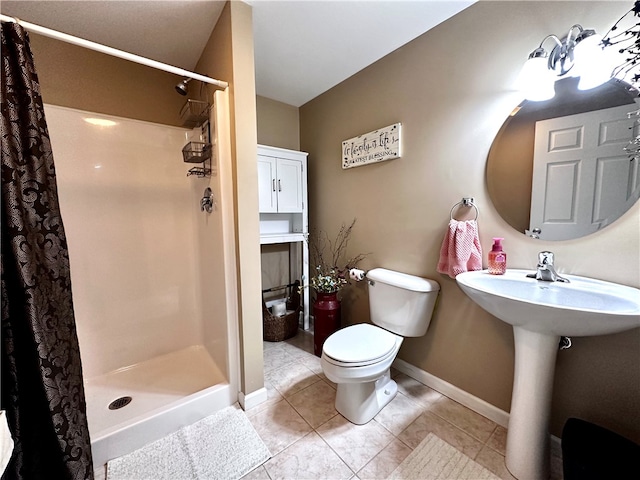 bathroom with tile patterned floors, toilet, and walk in shower