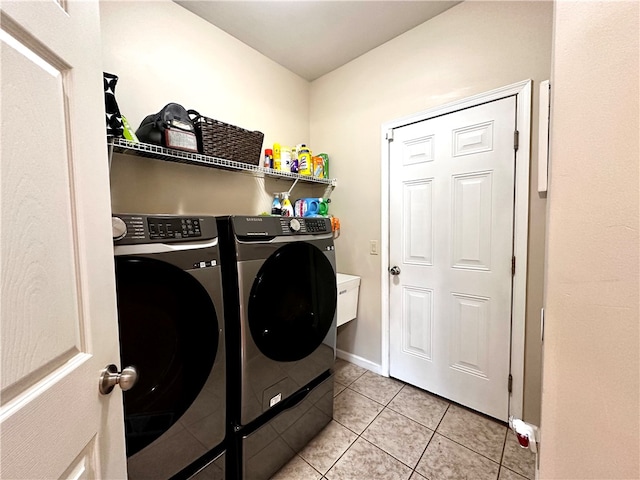 laundry area featuring washer and clothes dryer and light tile patterned floors