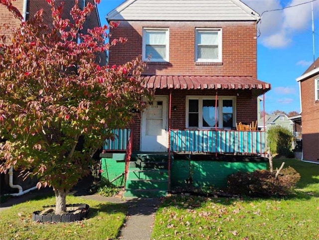 view of front of home with a front lawn and a porch