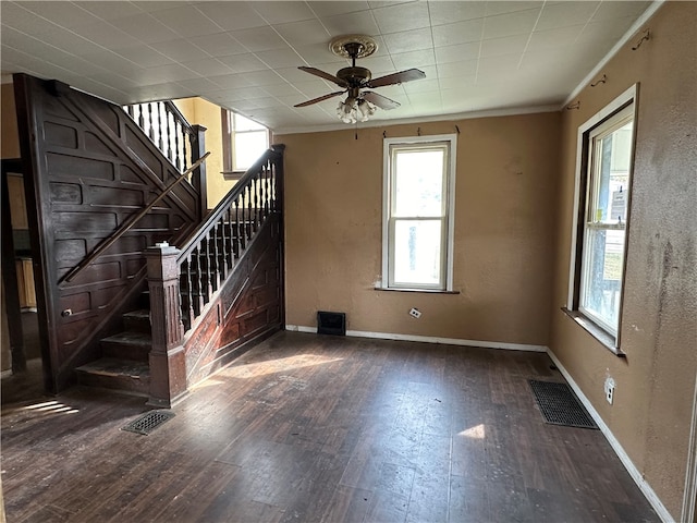 empty room with dark hardwood / wood-style floors and ceiling fan