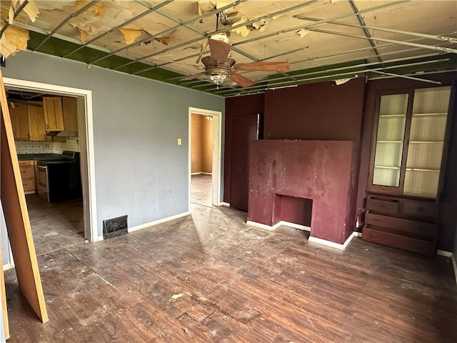 empty room featuring ceiling fan and dark hardwood / wood-style floors