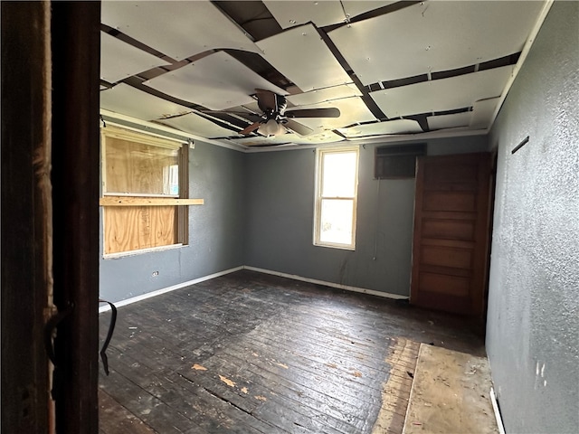 unfurnished room with dark hardwood / wood-style floors and ceiling fan