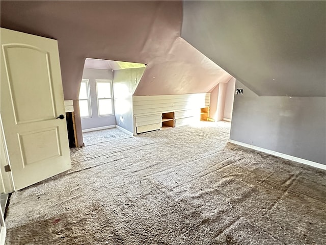 bonus room with light carpet and lofted ceiling