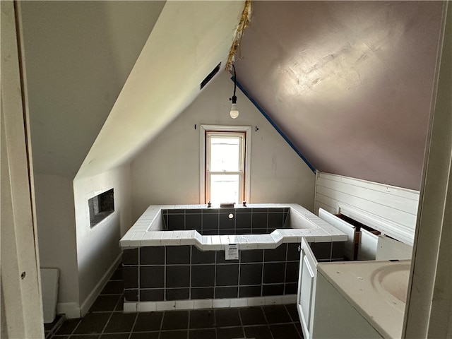 bathroom featuring vaulted ceiling and tile patterned flooring