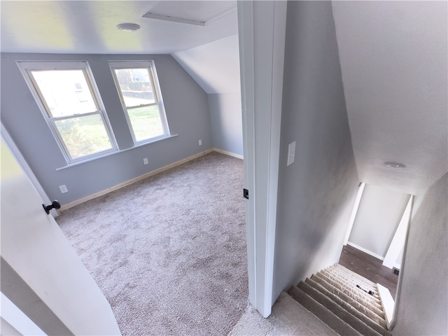 additional living space with light carpet and lofted ceiling