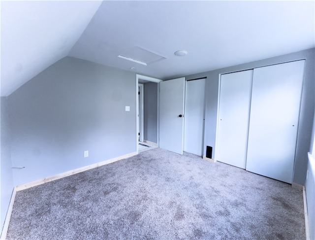 additional living space featuring carpet flooring and vaulted ceiling