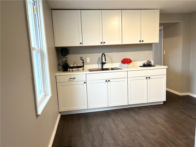 kitchen featuring dark hardwood / wood-style floors, white cabinetry, and sink