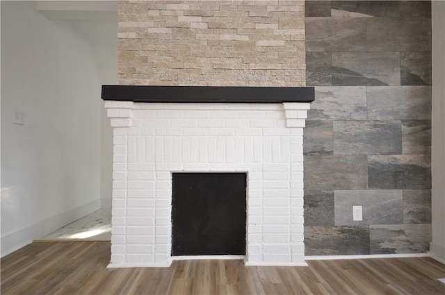 interior details featuring hardwood / wood-style flooring and a fireplace