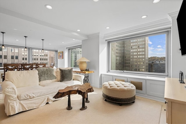 living room featuring ornamental molding, a chandelier, and a healthy amount of sunlight