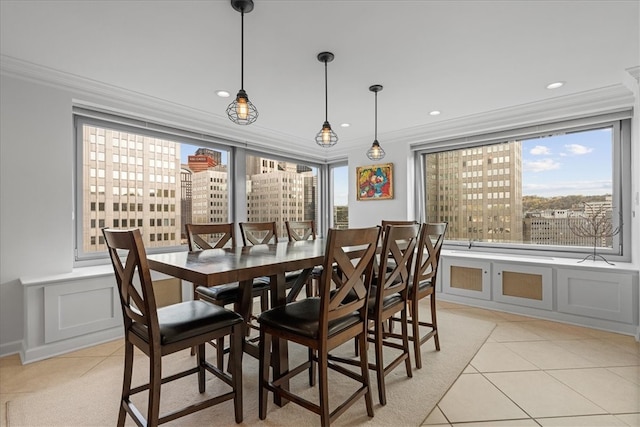 dining area with ornamental molding and light tile patterned floors