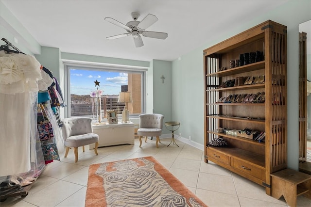 living area with ceiling fan and light tile patterned flooring