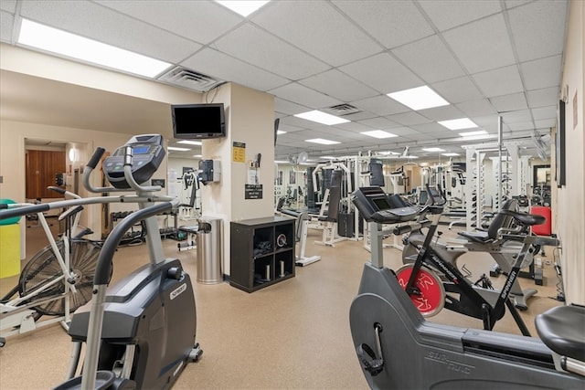 exercise room with a paneled ceiling