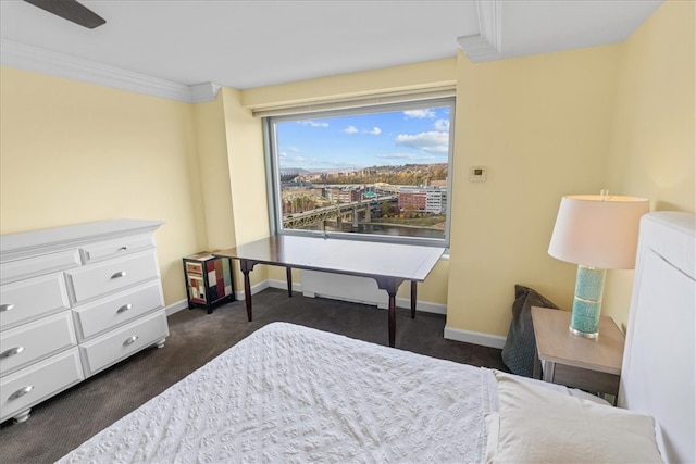 bedroom with ornamental molding and dark colored carpet