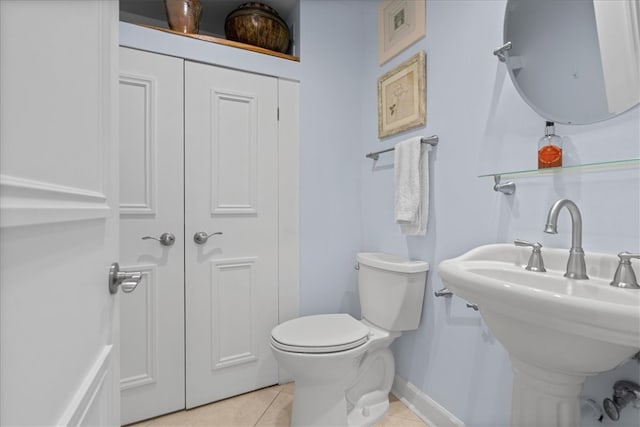 bathroom featuring toilet and tile patterned flooring