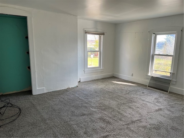 empty room with carpet floors and plenty of natural light