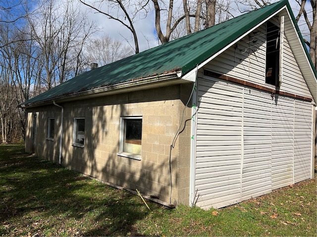 view of property exterior with a yard