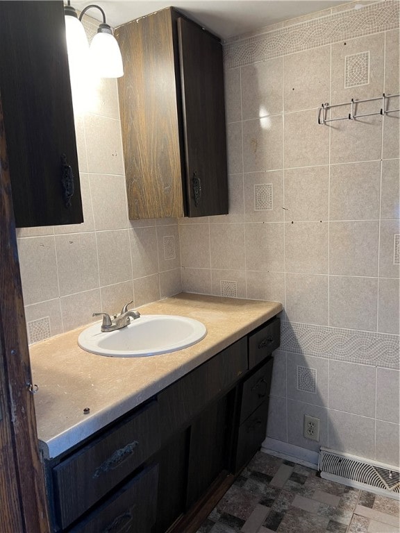 bathroom with vanity, tasteful backsplash, and tile walls