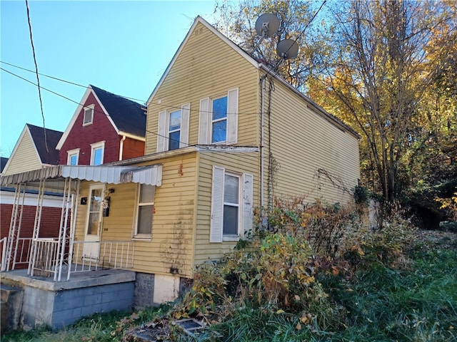 back of property featuring a porch