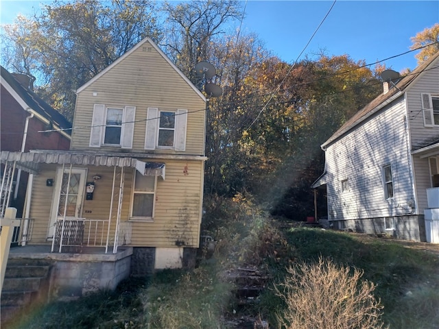 view of side of home featuring covered porch