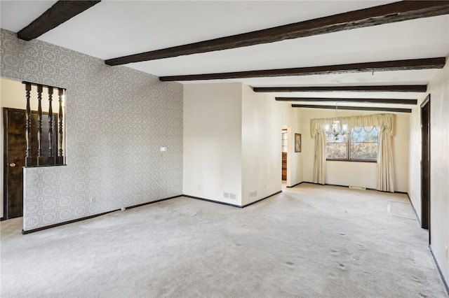 spare room with beamed ceiling, light colored carpet, and an inviting chandelier