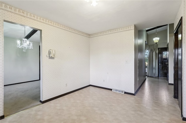 empty room featuring a notable chandelier