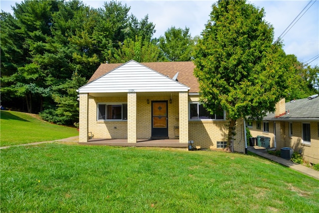 bungalow-style home with a front lawn