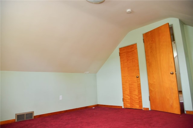 additional living space featuring carpet flooring and lofted ceiling