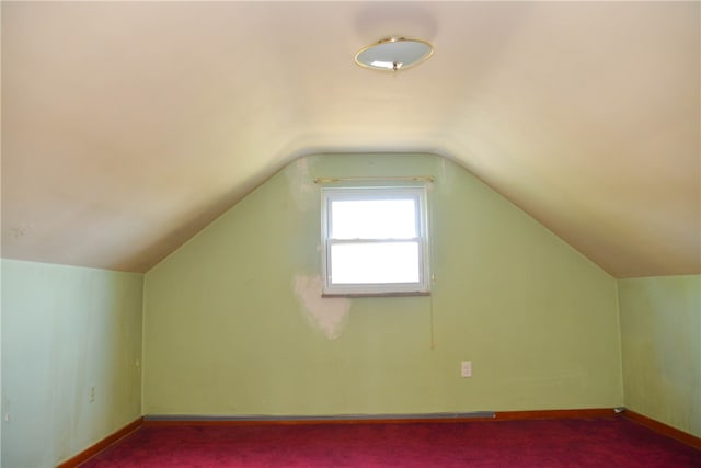 additional living space featuring lofted ceiling and carpet floors