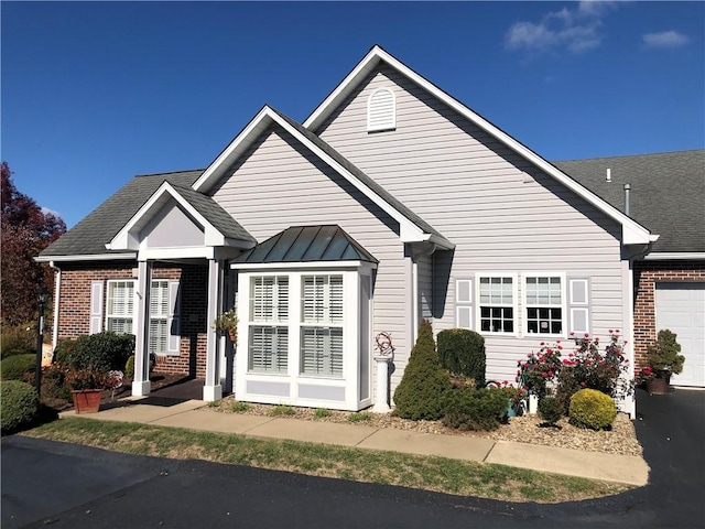 bungalow with brick siding and an attached garage