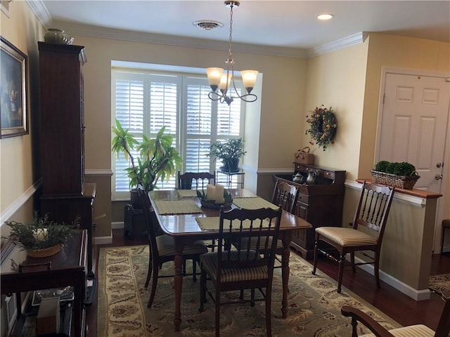 dining room with visible vents, a notable chandelier, wood finished floors, and a wealth of natural light