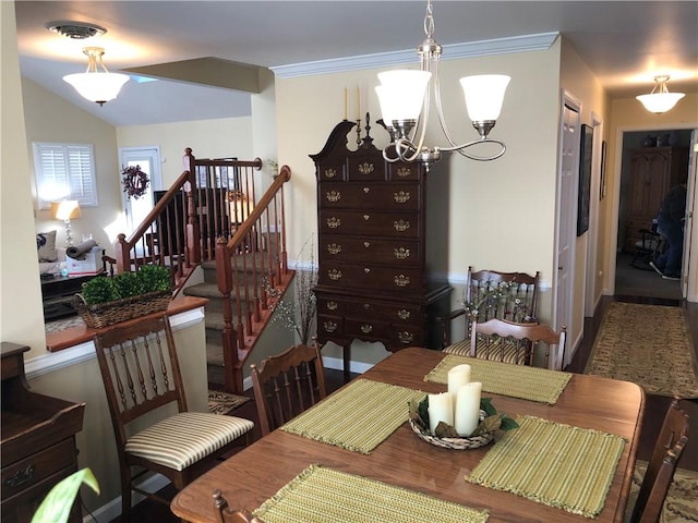 dining area with an inviting chandelier, wood finished floors, visible vents, and stairway