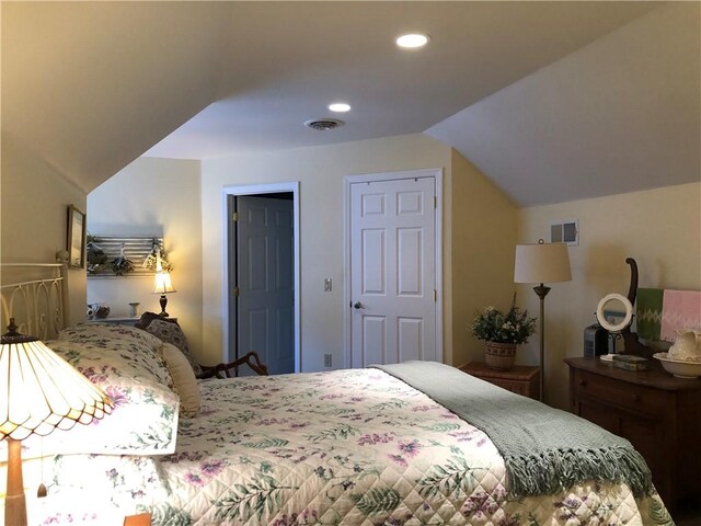 bedroom featuring vaulted ceiling, recessed lighting, and visible vents