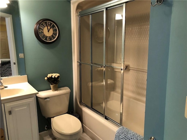 full bathroom featuring vanity, toilet, and shower / bath combination with glass door