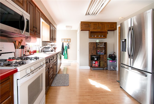 kitchen featuring sink, stainless steel appliances, and light hardwood / wood-style floors