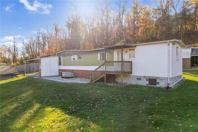 rear view of property featuring a patio area and a yard