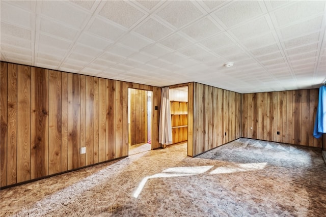 basement featuring wood walls and light colored carpet