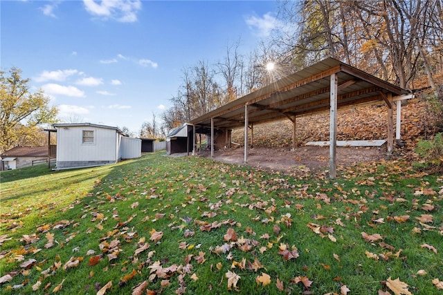 view of yard featuring an outbuilding and a carport