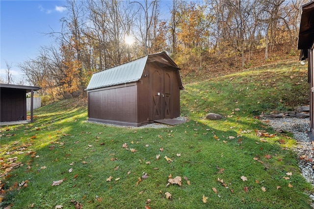 view of outbuilding with a yard